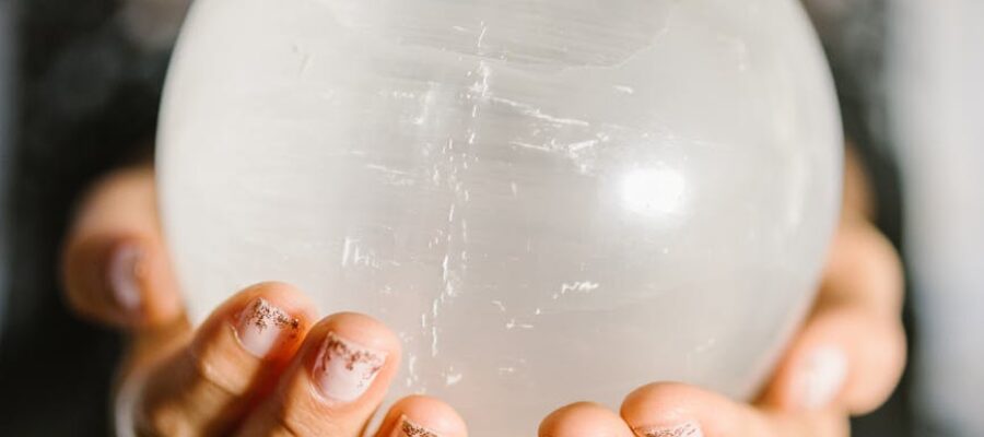 person holding white round ball